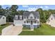 Charming two-story home with a well-manicured lawn, a two-car garage, and a welcoming front porch at 149 Great Oak Dr, Garner, NC 27529
