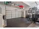 Well-lit garage featuring a home gym, ample storage, and a durable rubber floor at 149 Great Oak Dr, Garner, NC 27529