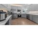 Modern kitchen with stainless steel appliances, gray cabinets, and quartz countertops at 149 Great Oak Dr, Garner, NC 27529