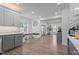 Open-concept kitchen with gray cabinets, modern appliances, and stylish seating at 149 Great Oak Dr, Garner, NC 27529
