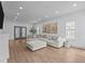 Bright living room with a large sectional sofa, hardwood floors and ample natural light at 149 Great Oak Dr, Garner, NC 27529
