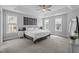 Bright main bedroom with a tray ceiling, ceiling fan, carpet, and large windows at 149 Great Oak Dr, Garner, NC 27529