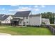 Back exterior view of a two-story house with a screened porch and well-maintained lawn at 149 Great Oak Dr, Garner, NC 27529