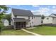 A charming home with a screened-in porch and a lush green lawn and garden at 149 Great Oak Dr, Garner, NC 27529