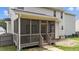 Inviting screened porch with wooden railings and steps, perfect for relaxing outdoors at 149 Great Oak Dr, Garner, NC 27529