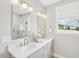 Bright bathroom featuring double vanity, modern lighting, and an enclosed glass shower at 160 Serene Xing, Fuquay Varina, NC 27526