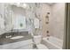 Bathroom featuring vanity sink, stylish wallpaper, a tub and shower combo at 160 Serene Xing, Fuquay Varina, NC 27526
