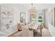Bright dining room featuring decorative trim, stylish lighting, and seating for eight at 160 Serene Xing, Fuquay Varina, NC 27526