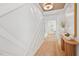 Hallway featuring decorative accent wall and wood flooring at 160 Serene Xing, Fuquay Varina, NC 27526