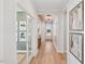 Bright hallway with decorative accent wall, wood flooring, and views to other rooms at 160 Serene Xing, Fuquay Varina, NC 27526