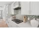 Modern kitchen with sleek countertops, stainless steel appliances, and herringbone backsplash at 160 Serene Xing, Fuquay Varina, NC 27526