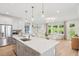 Bright, open kitchen and living room area with stainless steel appliances and ample seating at 160 Serene Xing, Fuquay Varina, NC 27526
