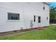 Exterior view of the house showing a well-maintained lawn and side door entrance at 163 W Lillington St, Angier, NC 27501