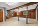 Spacious basement featuring wooden beams, and updated vinyl flooring, ideal for customizable living space at 163 W Lillington St, Angier, NC 27501