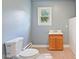 Simple bathroom with a classic toilet, a functional vanity, and a neutral color palette at 163 W Lillington St, Angier, NC 27501