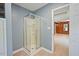Bathroom featuring a corner shower with clear glass door and open view of room with light wood vinyl flooring at 163 W Lillington St, Angier, NC 27501