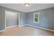 Bedroom featuring light vinyl flooring, a window, and grey painted walls at 163 W Lillington St, Angier, NC 27501