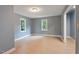 Bedroom features light vinyl flooring, two windows and grey paint at 163 W Lillington St, Angier, NC 27501