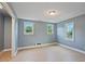 Bedroom featuring light vinyl flooring, two windows, and grey painted walls at 163 W Lillington St, Angier, NC 27501