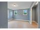 Light-filled bedroom featuring blue walls, hardwood floors, modern windows, and ample closet space at 163 W Lillington St, Angier, NC 27501