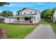 Well-maintained two-story home with white siding, a covered porch, and a spacious driveway at 163 W Lillington St, Angier, NC 27501