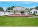Charming two-story home featuring a classic white exterior, brick foundation, and lush green lawn at 163 W Lillington St, Angier, NC 27501