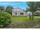 Inviting home with a covered front porch, a well-manicured lawn, and mature trees at 163 W Lillington St, Angier, NC 27501