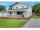Beautiful two-story home with white siding, a covered porch, and a paved driveway at 163 W Lillington St, Angier, NC 27501