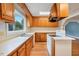 Well-lit kitchen with wood cabinets, white countertops, modern appliances, and an adjacent dining area at 163 W Lillington St, Angier, NC 27501