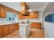 Spacious kitchen with wood cabinets, laminate countertops, kitchen island, and a well-lit interior at 163 W Lillington St, Angier, NC 27501