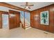 The living room features wood paneling, wood ceiling beam, ceiling fan, wood flooring and natural light at 163 W Lillington St, Angier, NC 27501