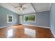 Inviting living room with hardwood floors, a ceiling fan, and a view of the covered porch at 163 W Lillington St, Angier, NC 27501