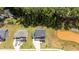 Aerial view of a residential property with a manicured lawn, a pond, and surrounding trees at 165 Hickory Grv Dr, Sanford, NC 27330