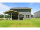Spacious backyard with a covered patio featuring a hot tub and outdoor dining area, perfect for entertaining at 165 Hickory Grv Dr, Sanford, NC 27330