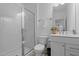 Clean bathroom with glass door shower, sleek vanity, and neutral tile flooring at 165 Hickory Grv Dr, Sanford, NC 27330