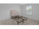 Bedroom with carpet and metal bedframe with a large window providing plenty of natural light at 165 Hickory Grv Dr, Sanford, NC 27330