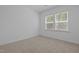 Neutral carpeted bedroom with double windows bringing in natural light at 165 Hickory Grv Dr, Sanford, NC 27330