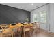 Bright dining room features modern decor, a striking accent wall, and a large window with natural light at 165 Hickory Grv Dr, Sanford, NC 27330