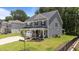 Well-maintained two-story home with a covered porch, three-car garage, and beautifully landscaped front yard at 165 Hickory Grv Dr, Sanford, NC 27330