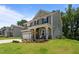 Charming two-story home with a well-maintained lawn and a covered front porch with tasteful landscaping at 165 Hickory Grv Dr, Sanford, NC 27330