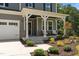 Charming front porch with decorative columns and seating area, adding curb appeal to this home at 165 Hickory Grv Dr, Sanford, NC 27330