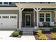 Inviting front porch featuring stylish seating and a 'Welcome Home' sign, creating a warm and welcoming entrance at 165 Hickory Grv Dr, Sanford, NC 27330