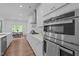 Well-lit kitchen boasts stainless steel appliances, white cabinets, and a view to the dining area at 165 Hickory Grv Dr, Sanford, NC 27330