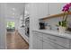 Modern kitchen with white cabinets, stainless steel appliances, and a view of the dining area at 165 Hickory Grv Dr, Sanford, NC 27330