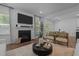 Bright living room with modern fireplace, mantle, and open floor plan to the dining area at 165 Hickory Grv Dr, Sanford, NC 27330