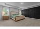 Main bedroom features tray ceiling, modern accent wall, and bedside tables with lamps at 165 Hickory Grv Dr, Sanford, NC 27330