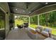 Covered patio with outdoor seating, ceiling fan, and a view of the lush green lawn at 165 Hickory Grv Dr, Sanford, NC 27330