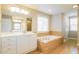Large bathroom with soaking tub, double vanity, a large mirror, and plenty of counter space at 165 Sutherland Dr, Franklinton, NC 27525