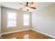 A well-lit bedroom features two windows, hardwood floors, and a ceiling fan at 165 Sutherland Dr, Franklinton, NC 27525