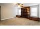 Bedroom featuring a large built-in bookshelf, two storage boxes, neutral carpet and ceiling fan at 165 Sutherland Dr, Franklinton, NC 27525